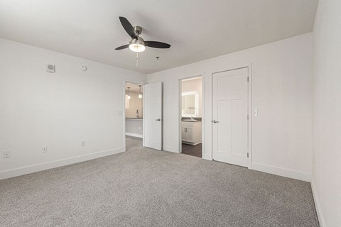 Bedroom with a ceiling fan and doors to a 2nd bathroom and closet  at Signature Pointe Apartment Homes, Athens, AL