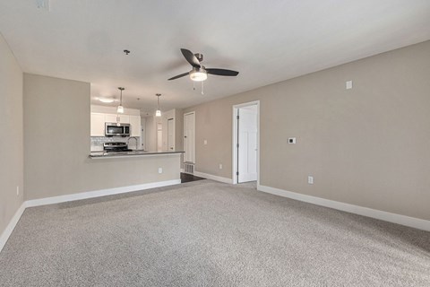 A spacious living and dining room with a ceiling fan at Signature Pointe Apartment Homes in Athens, AL
