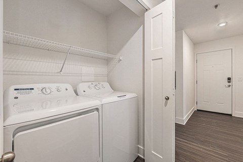 a washer and dryer in a laundry room  at Signature Pointe Apartment Homes, Athens, 35611