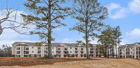 the view of an apartment building with trees in front of it  at Signature Pointe Apartment Homes, Athens