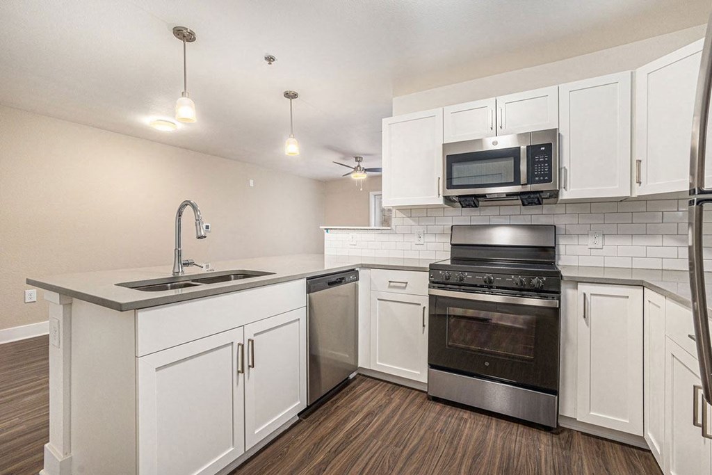 a kitchen with white cabinets and stainless steel appliances at Stoney Pointe Apartment Homes, Wichita, KS