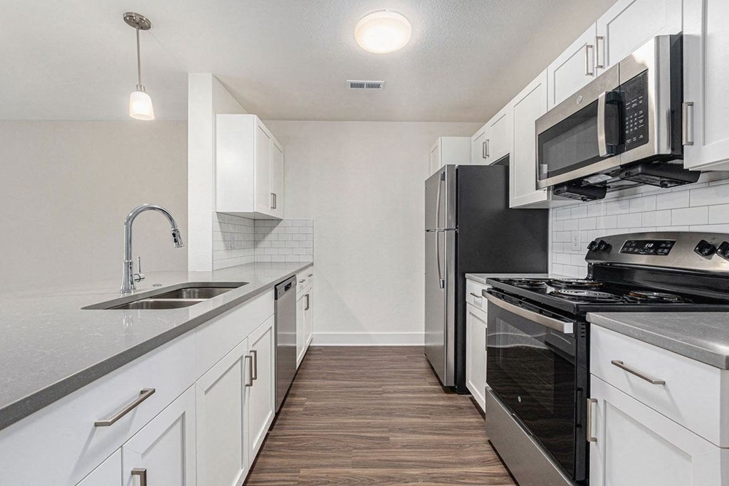 a kitchen with stainless steel appliances and white cabinets at Stoney Pointe Apartment Homes, Kansas, 67226