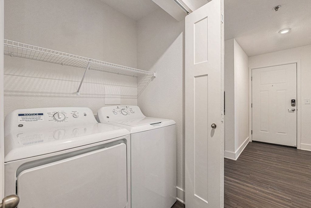 a washer and dryer in a laundry room with a closet at Stoney Pointe Apartment Homes, Wichita