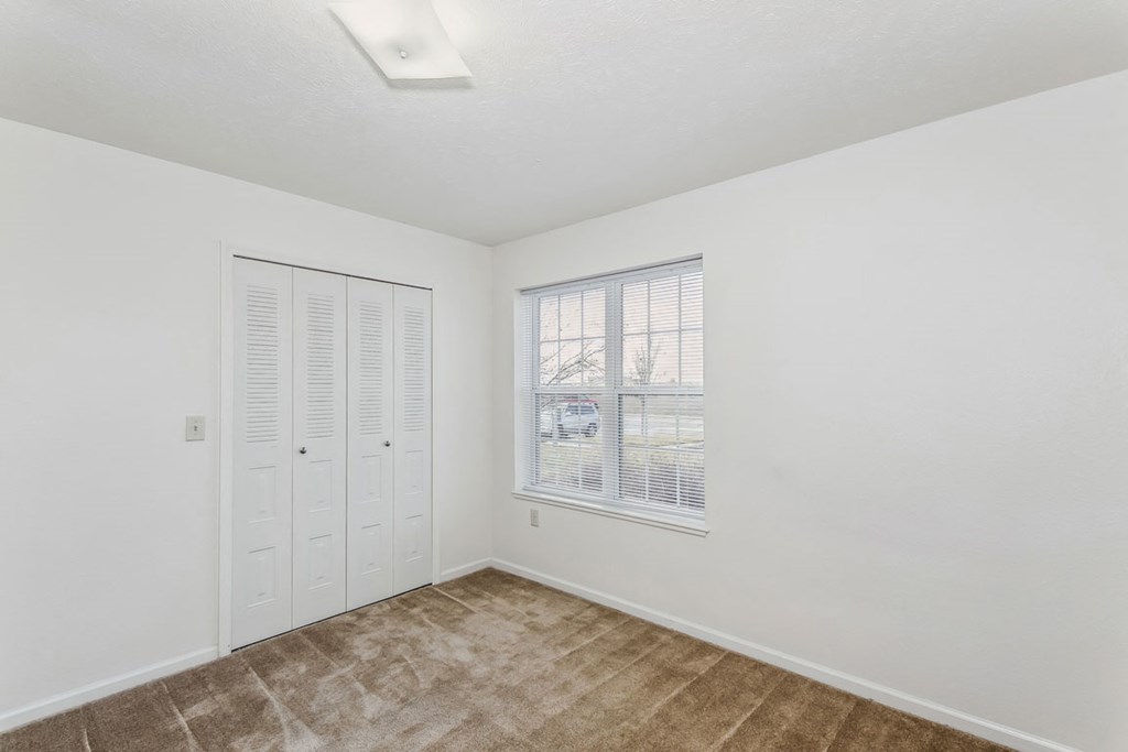 Bedroom with Large Window at Stoney Pointe Apartment Homes in Wichita, KS