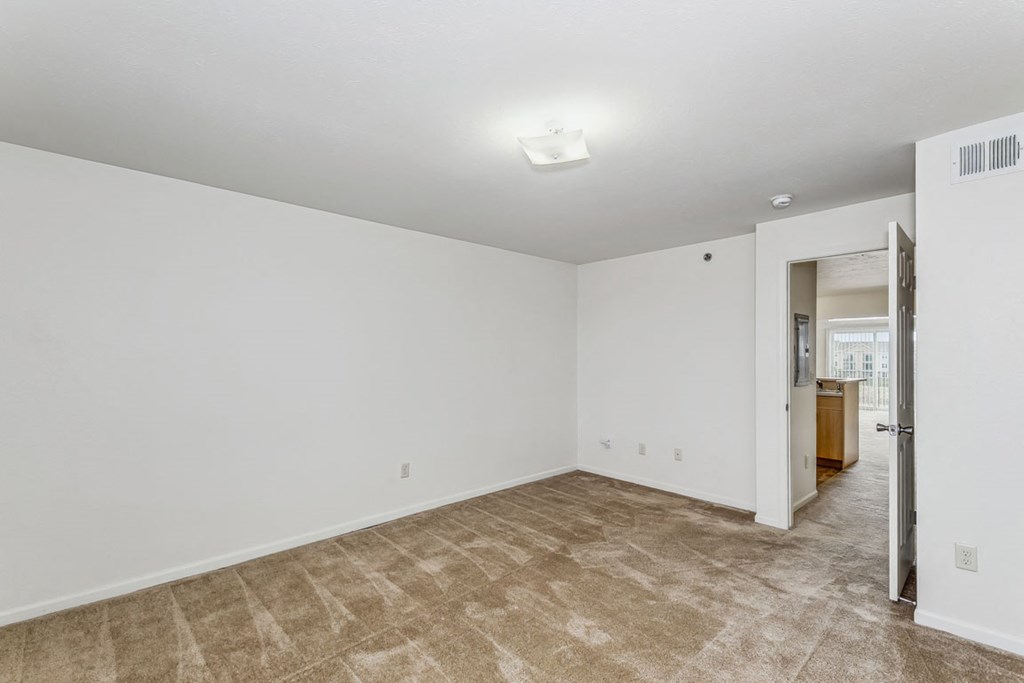 Spacious Bedroom with Plush Carpeting at Stoney Pointe Apartment Homes in Wichita, KS