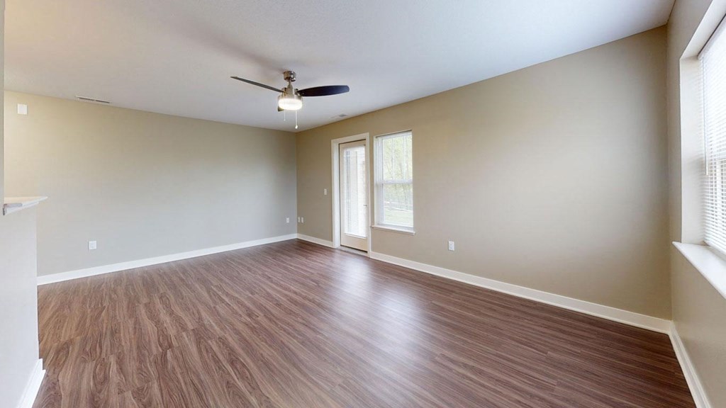 enlarged living room with extra windows and a ceiling fan at Strathmore Apartment Homes, West Des Moines, 50266