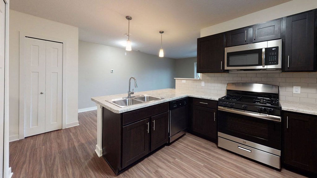 a kitchen with a dishwasher, stove and a microwave at Strathmore Apartment Homes, West Des Moines, 50266