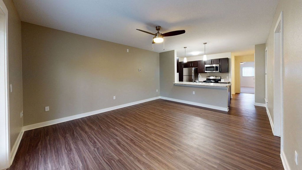 spacious living room and kitchen with hard-surface flooring at Strathmore Apartment Homes, West Des Moines, 50266