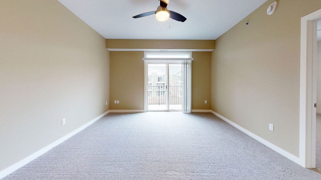 living room with a ceiling fan and 9' ceiling at Strathmore Apartment Homes, West Des Moines, 50266
