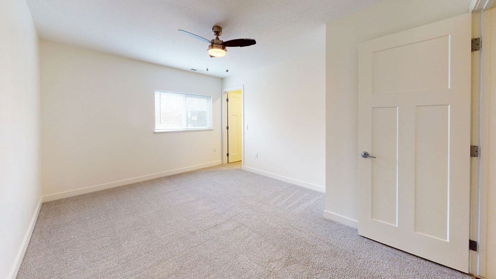 bedroom with ceiling fan and a door to a closet at Strathmore Apartment Homes, West Des Moines, 50266