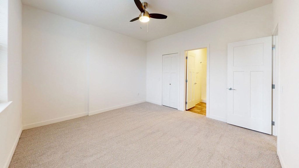 a bedroom with walk-in closet and second bathroom at Strathmore Apartment Homes, West Des Moines, 50266