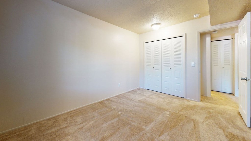 a bedroom with a closet at Swiss Valley Apartments, Wyoming, Michigan