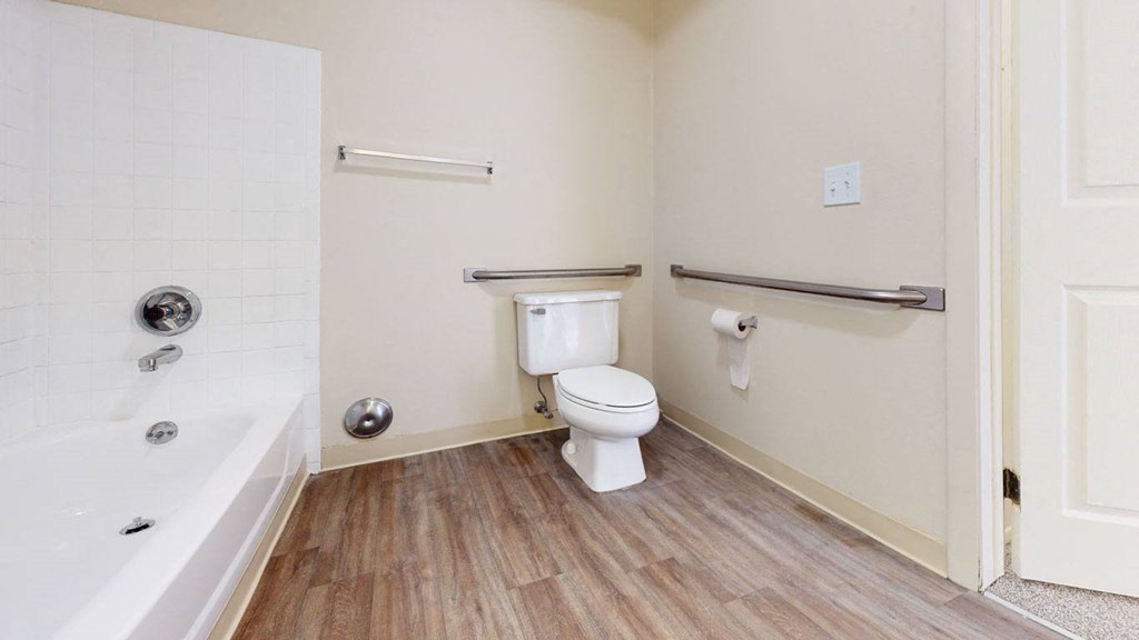 a spacious bathroom with a toilet and a bath tub at Swiss Valley Apartments, Wyoming