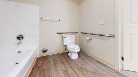 a spacious bathroom with a toilet and a bath tub at Swiss Valley Apartments, Wyoming