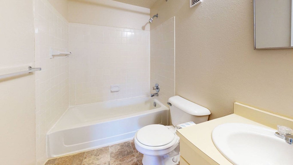 a bathroom with a toilet and a tub and a sink at Swiss Valley Apartments, Michigan, 49509