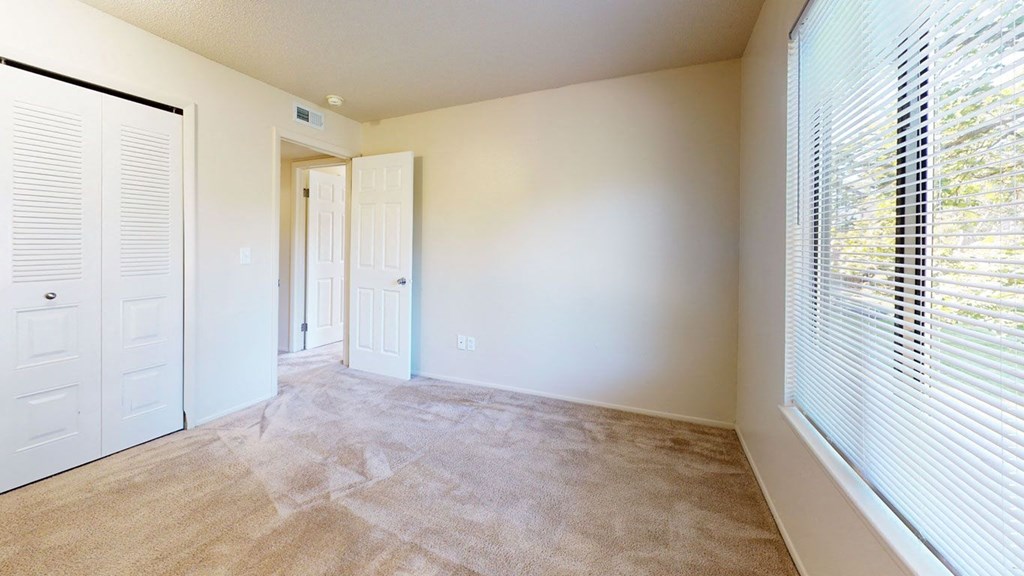 a bedroom with a large window at Swiss Valley Apartments, Wyoming