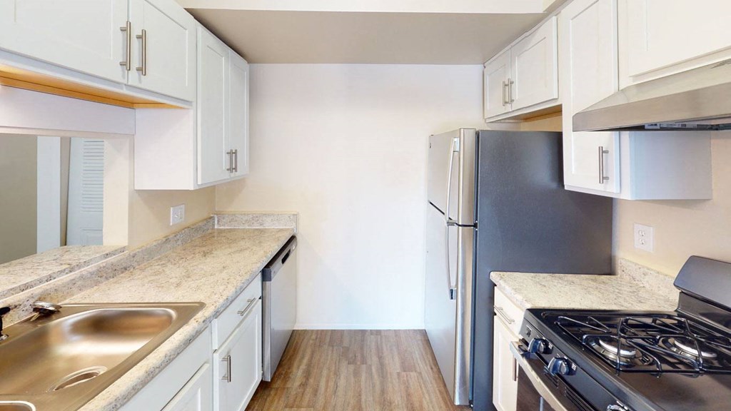 a kitchen with white cabinets and stainless steel appliancesat Swiss Valley Apartments, Wyoming, MI, 49509