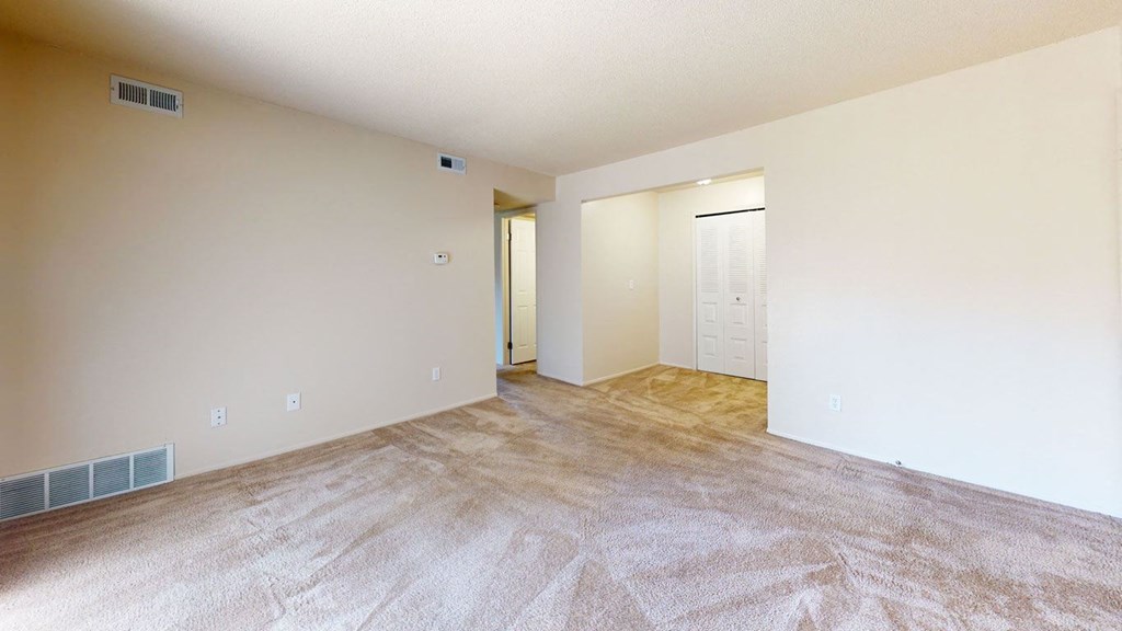 spacious living room and dining area with closet space at Swiss Valley Apartments, Wyoming, Michigan