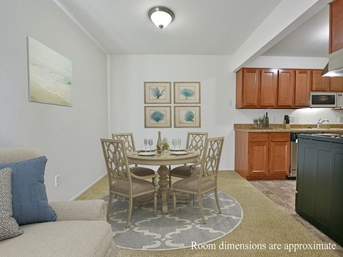 a kitchen and dining room with a table and chairs
