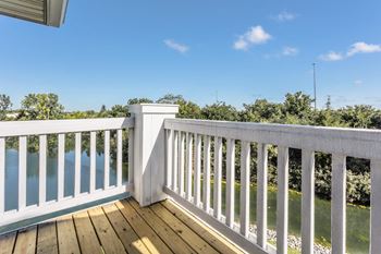 A white railing overlooks a body of water