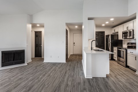 A modern kitchen with a white island and stainless steel appliances. at Sundance Apartments, Indianapolis, IN
