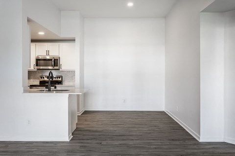 A kitchen with white walls and wooden floors. at Sundance Apartments, Indianapolis, 46237