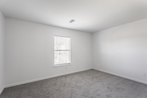 A room with a window and carpeted floor. at Sundance Apartments, Indianapolis, IN