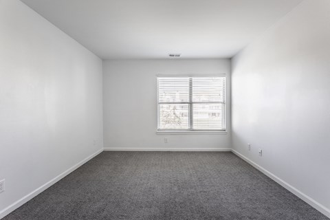 A room with a window and carpeted floor. at Sundance Apartments, Indianapolis