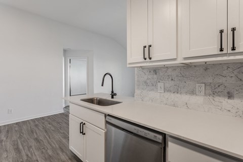 A kitchen with a white sink and cabinets. at Sundance Apartments, Indianapolis, 46237