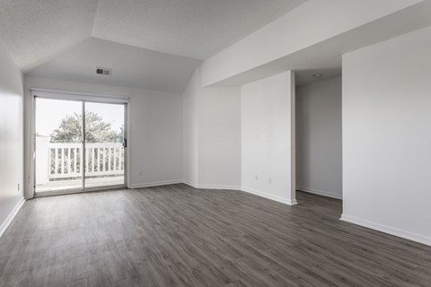 A room with a sliding glass door leading to a balcony. at Sundance Apartments, Indianapolis, IN