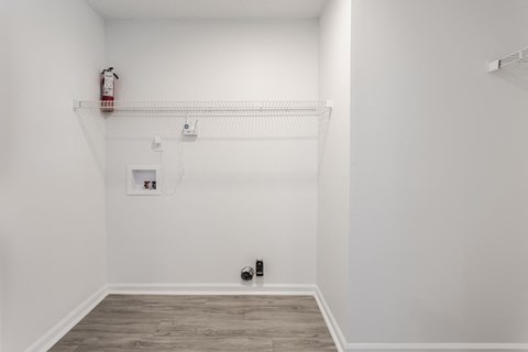 A white room with a fire extinguisher on the wall. at Sundance Apartments, Indiana, 46237
