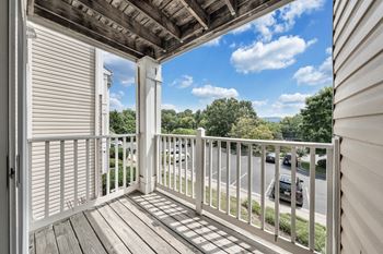 A balcony with a white railing and a view of the street below. at Sunscape Apartments, Virginia, 24018