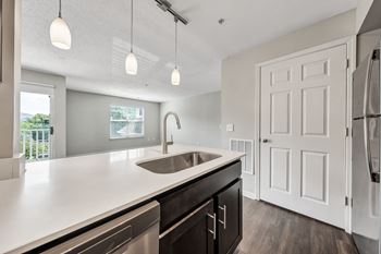 A modern kitchen with a white countertop and a stainless steel sink. at Sunscape Apartments, Roanoke, 24018