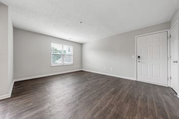 A room with wooden flooring and white walls. at Sunscape Apartments, Roanoke, Virginia