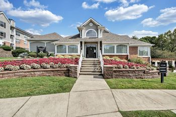 A house with a front yard and a sign that says  at Sunscape Apartments, Virginia, 24018