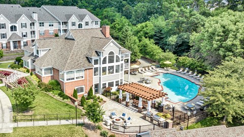 A large building with a pool in front of it. at Sunscape Apartments, Virginia