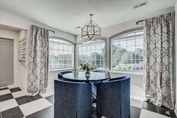 A dining room with a round table and chairs. at Sunscape Apartments, Roanoke, VA, 24018