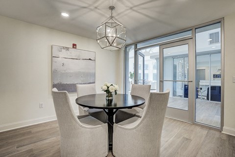 A dining room with a table and chairs. at Sunscape Apartments, Virginia