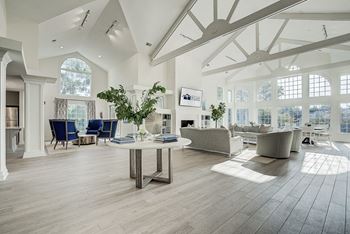 A spacious living room with a large table and chairs. at Sunscape Apartments, Virginia