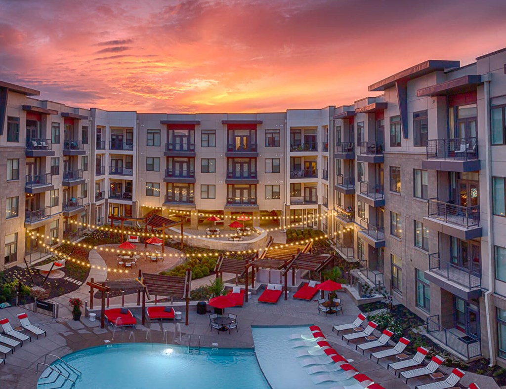 an aerial view of an apartment complex with a pool and lounge chairs  at Avant & Avant II, Carmel, IN, 46032