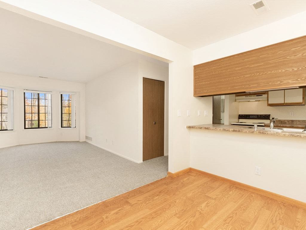 an empty living room and kitchen with a wood floor at Tanglewood Apartments, Oak Creek, WI, 53154