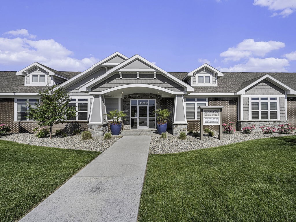 a large house with a sidewalk in front of it at Trade Winds Apartment Homes in Elkhorn, NE 68022