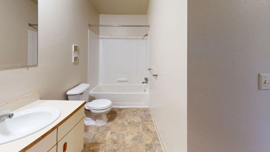 a bathroom with a sink toilet and a shower  at Trappers Cove Apartments, Lansing, MI