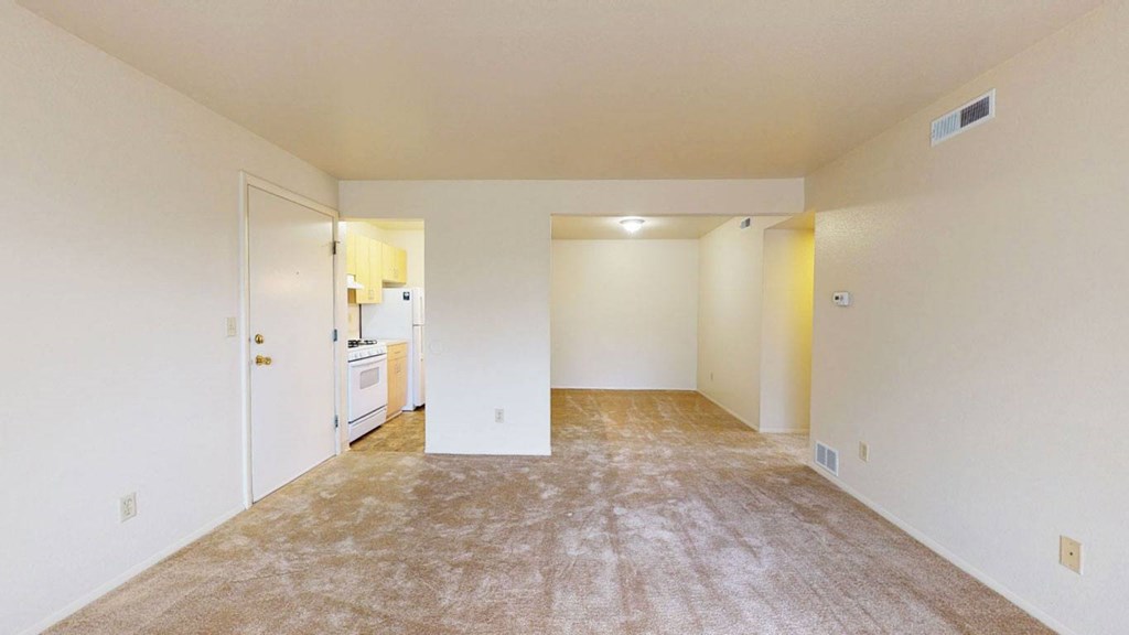 living room and dining room with breakfast bar at Trappers Cove Apartments, Lansing, Michigan