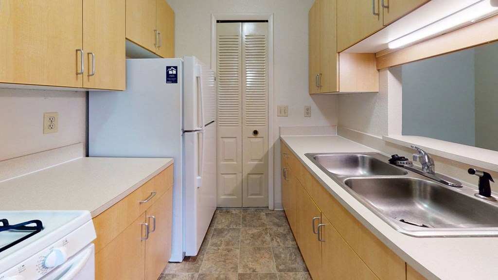 a kitchen with a pantry at Trappers Cove Apartments, Lansing, MI