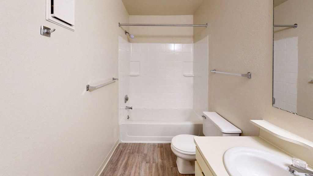 a bathroom with a sink toilet and a shower  at Trappers Cove Apartments, Michigan, 48910