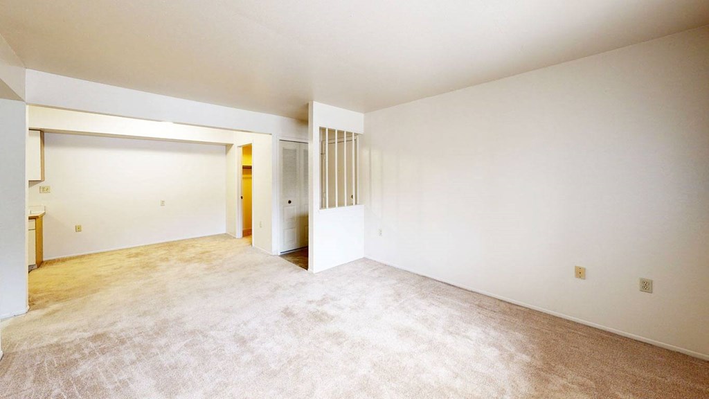 living room and dining room with carpeting  at Trappers Cove Apartments, Michigan