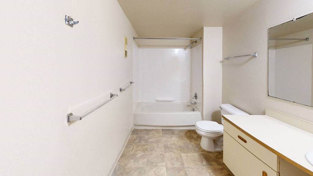 a bathroom with a sink toilet and a bath tub  at Trappers Cove Apartments, Michigan