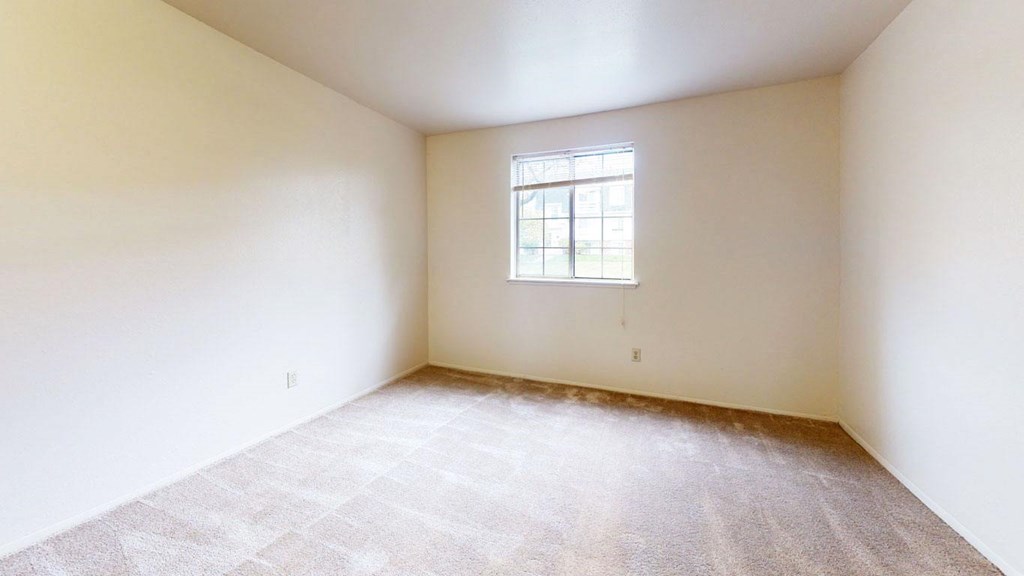 second bedroom with a window  at Trappers Cove Apartments, Lansing, MI, 48910