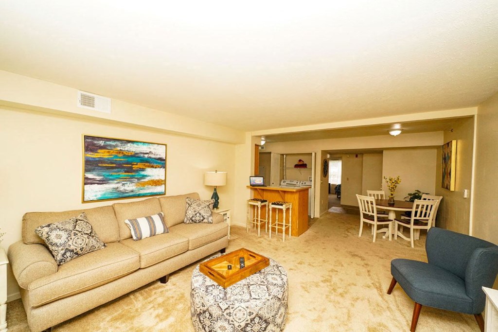 a living room with a couch and a table at Trillium Pointe Apartment Homes, Jackson, 49201